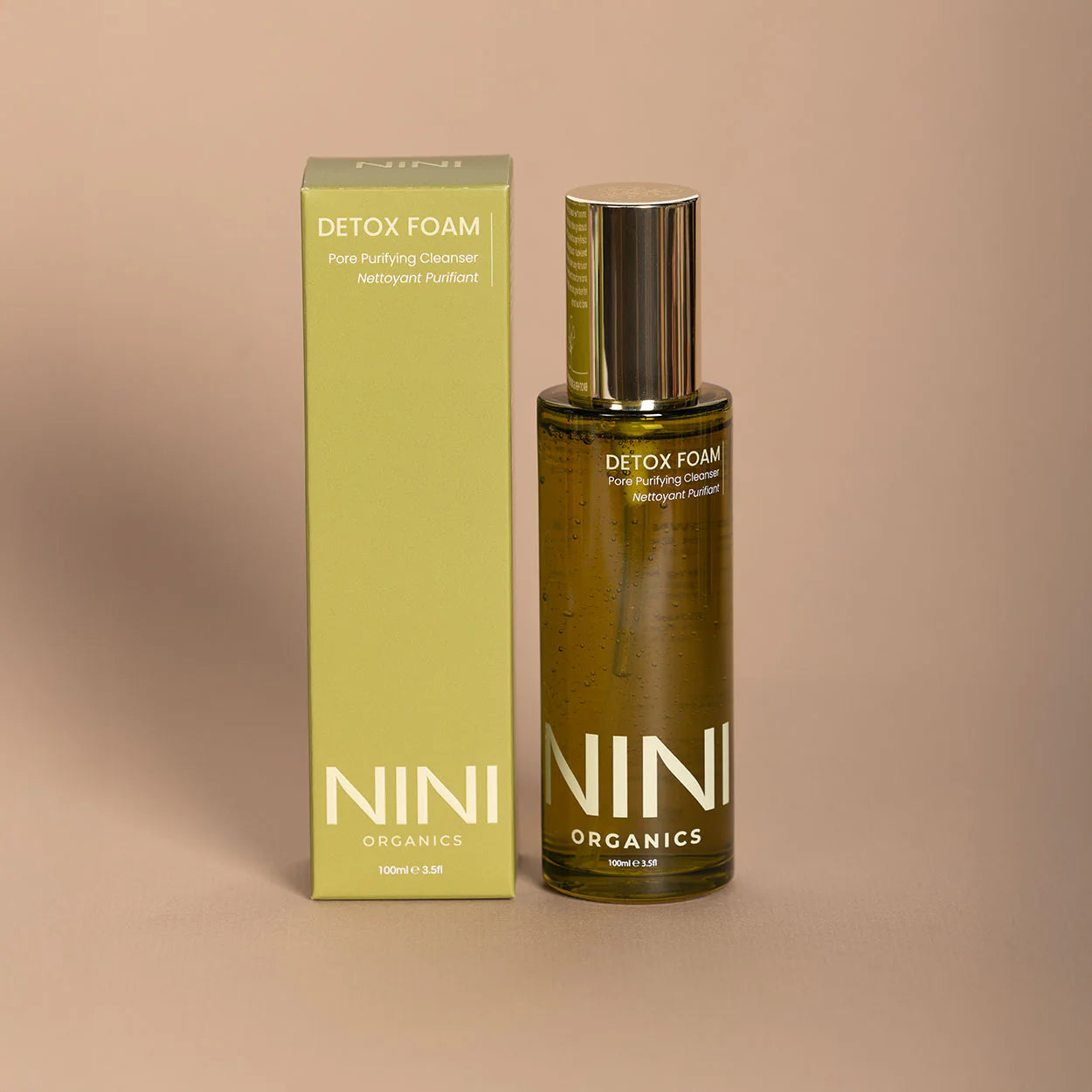 NINI Organics detox foam bottle and packaging on a beige background