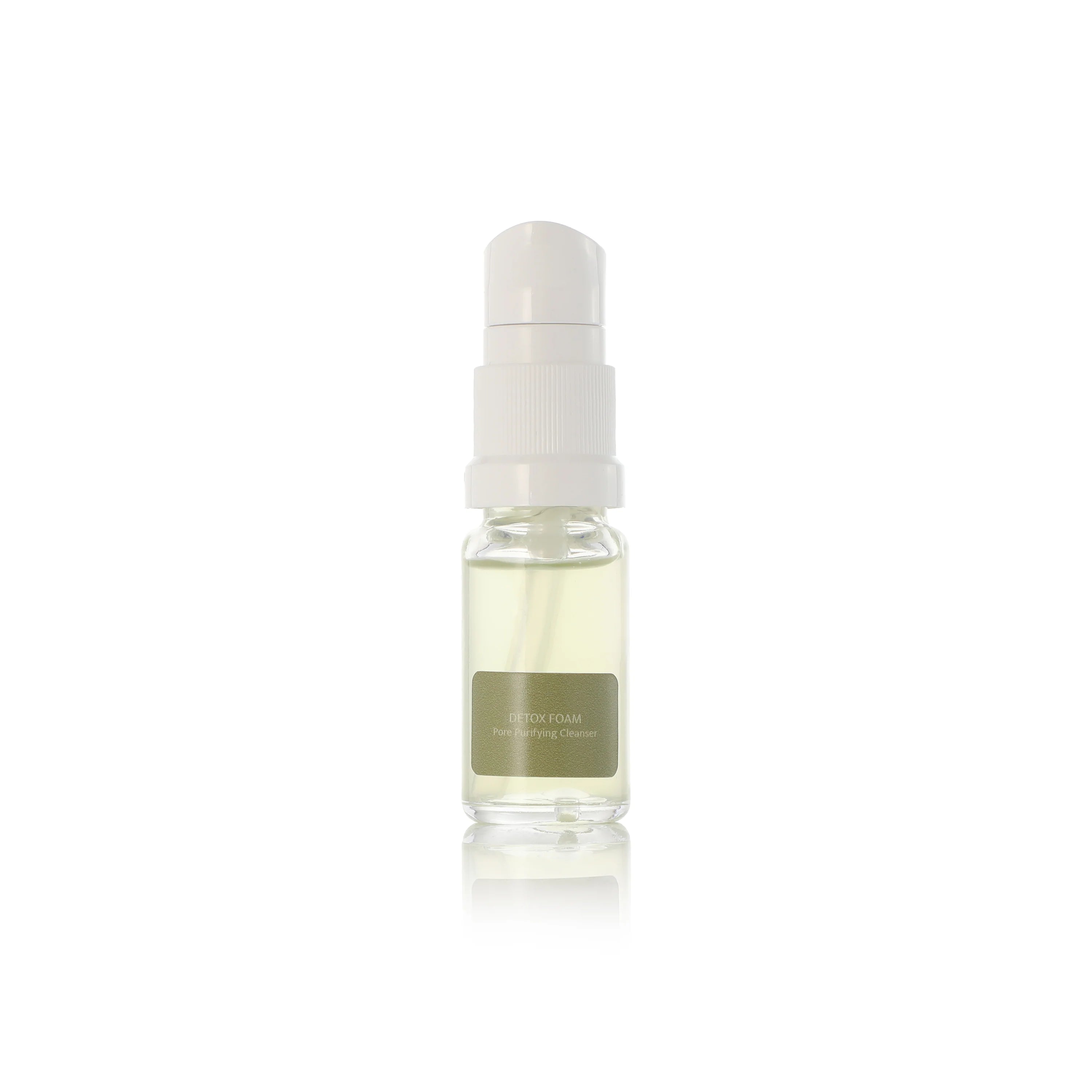 Small glass bottle NINI Organics detox foaming cleanser with a white cap on a white background