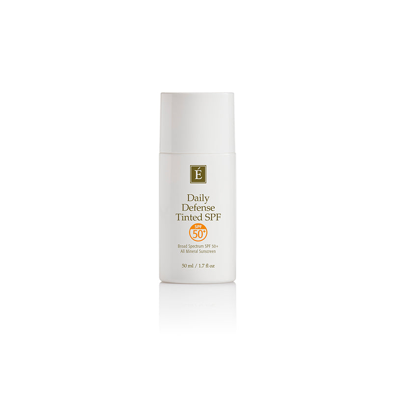 A bottle of Eminence Organic Daily Defence Tinted SPF sunscreen.