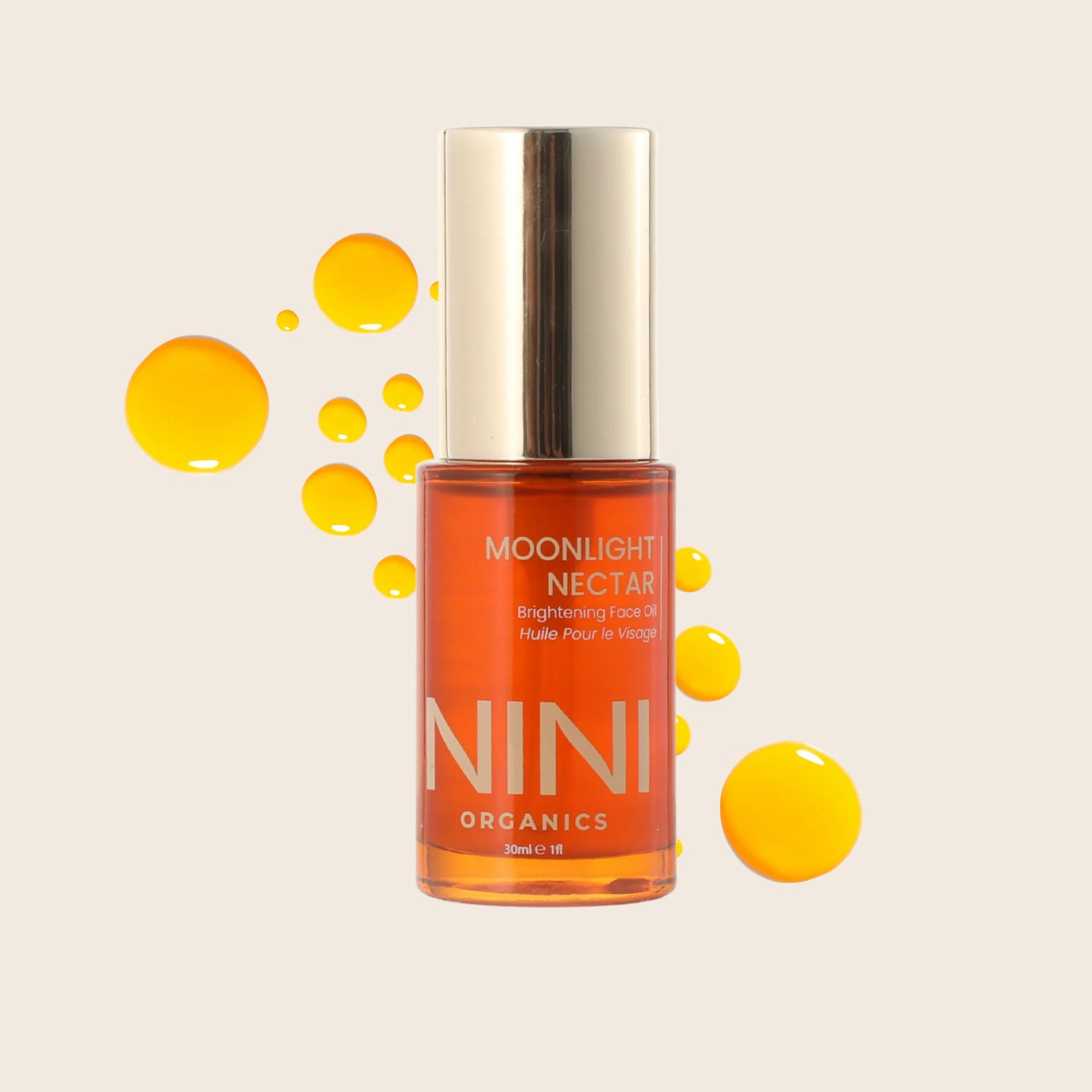 Bottle of NINI Organics Moonlight Nectar on a beige background with yellow droplets.