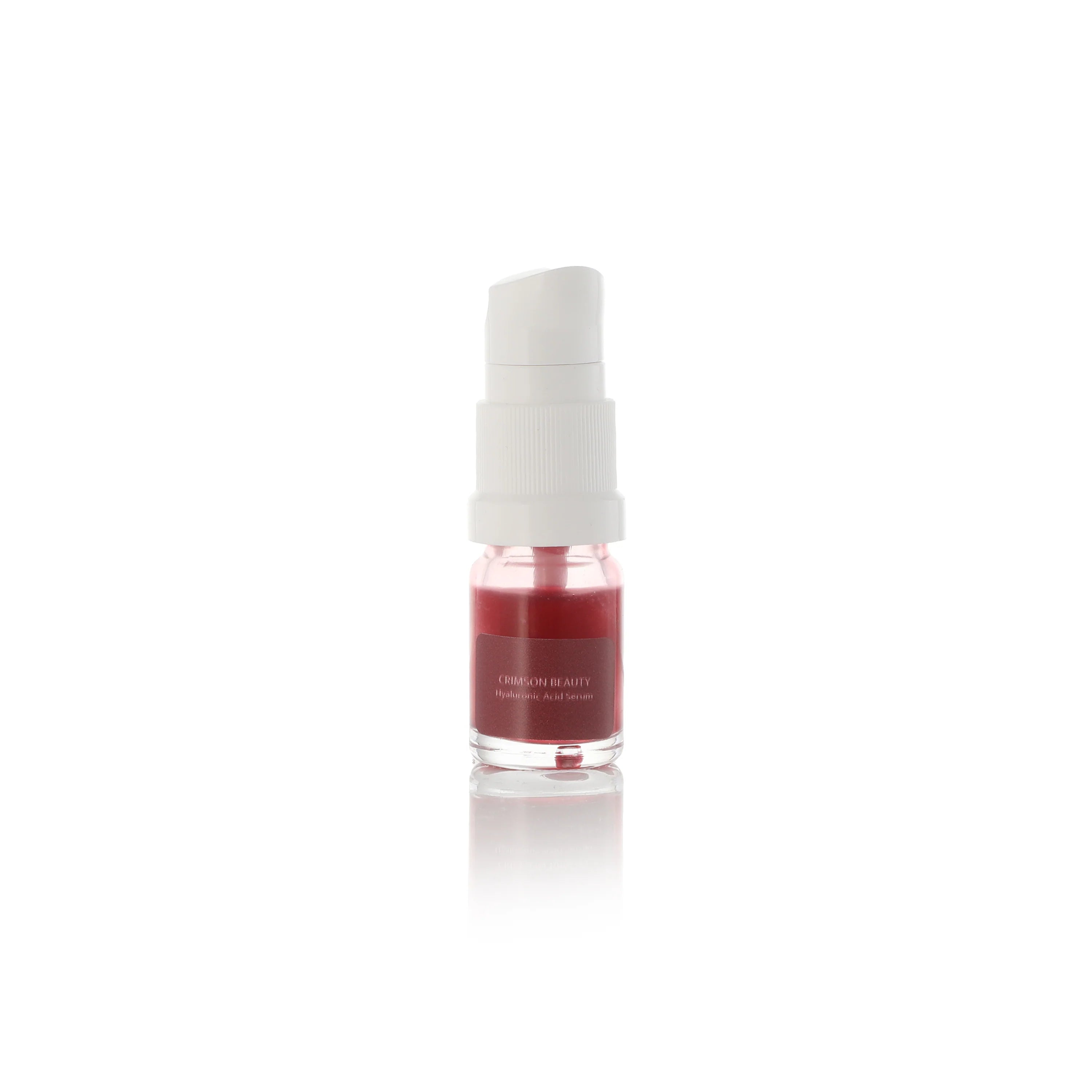 Small bottle with a white cap and red liquid on a white background crimson beauty travel size