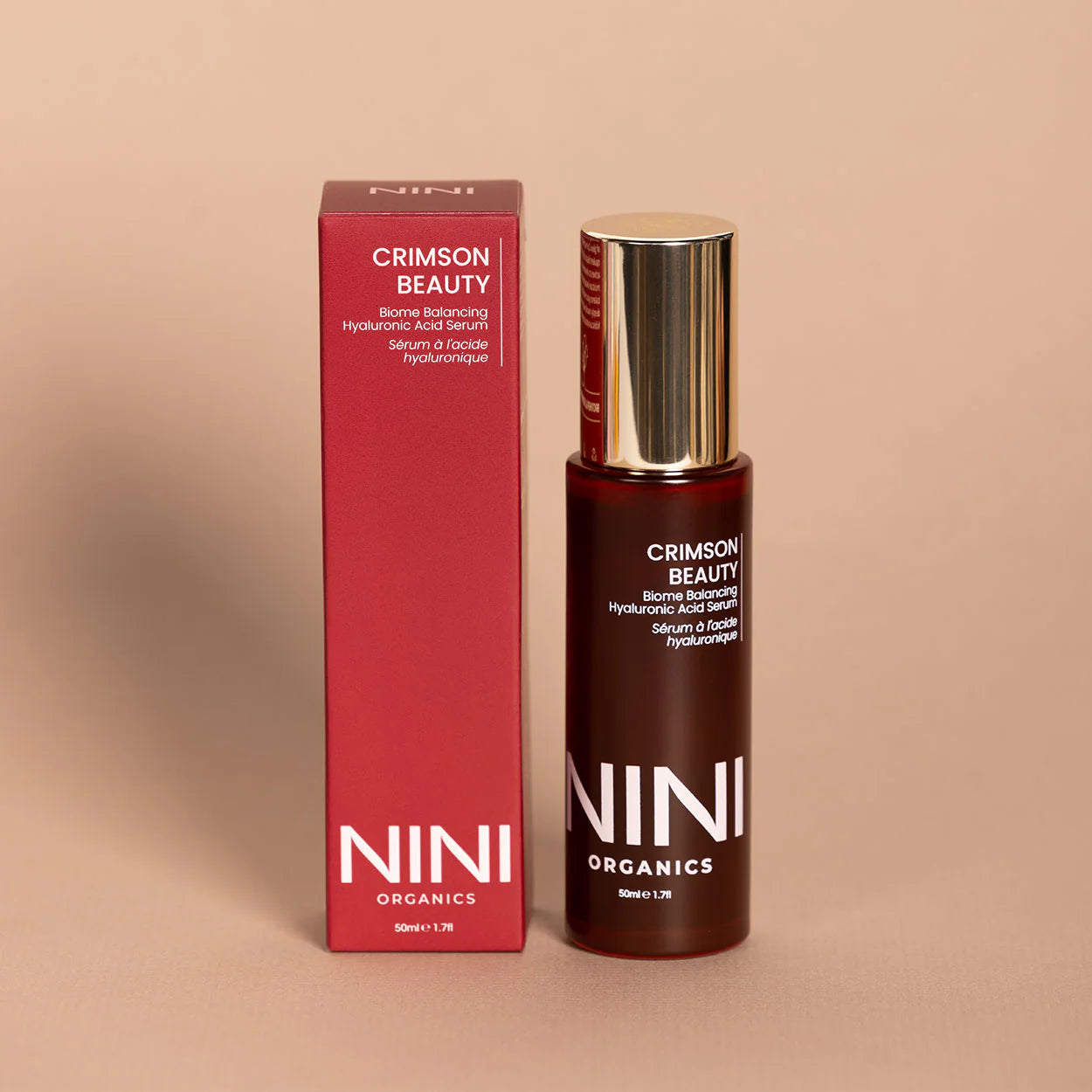 NINI Organics Crimson Beauty serum bottle and packaging on a beige background