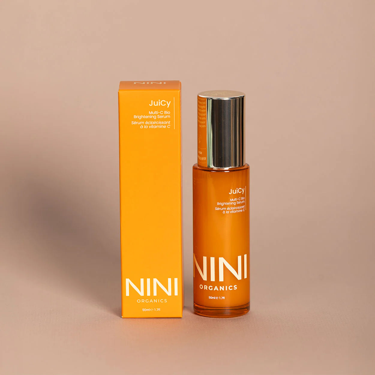 NINI Organics skincare Juicy Vitamin C product with packaging on a beige background