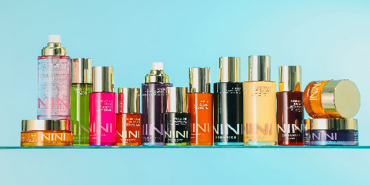 NINI skincare products with 'NINI' branding on a light blue background