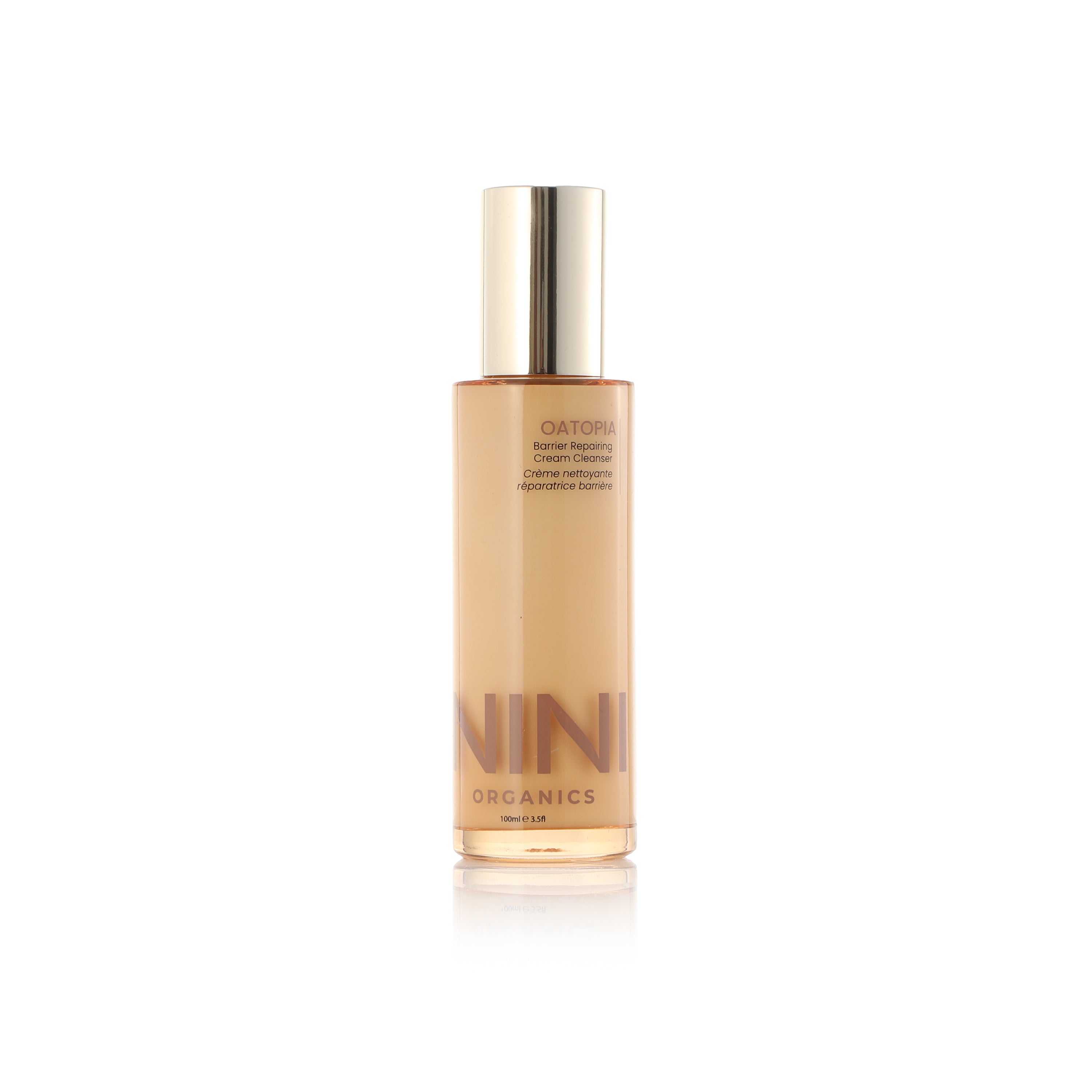 Oatopia Cream Cleanser NINI Organics skincare - Skincare bottle with gold cap and visible brand name on a white background