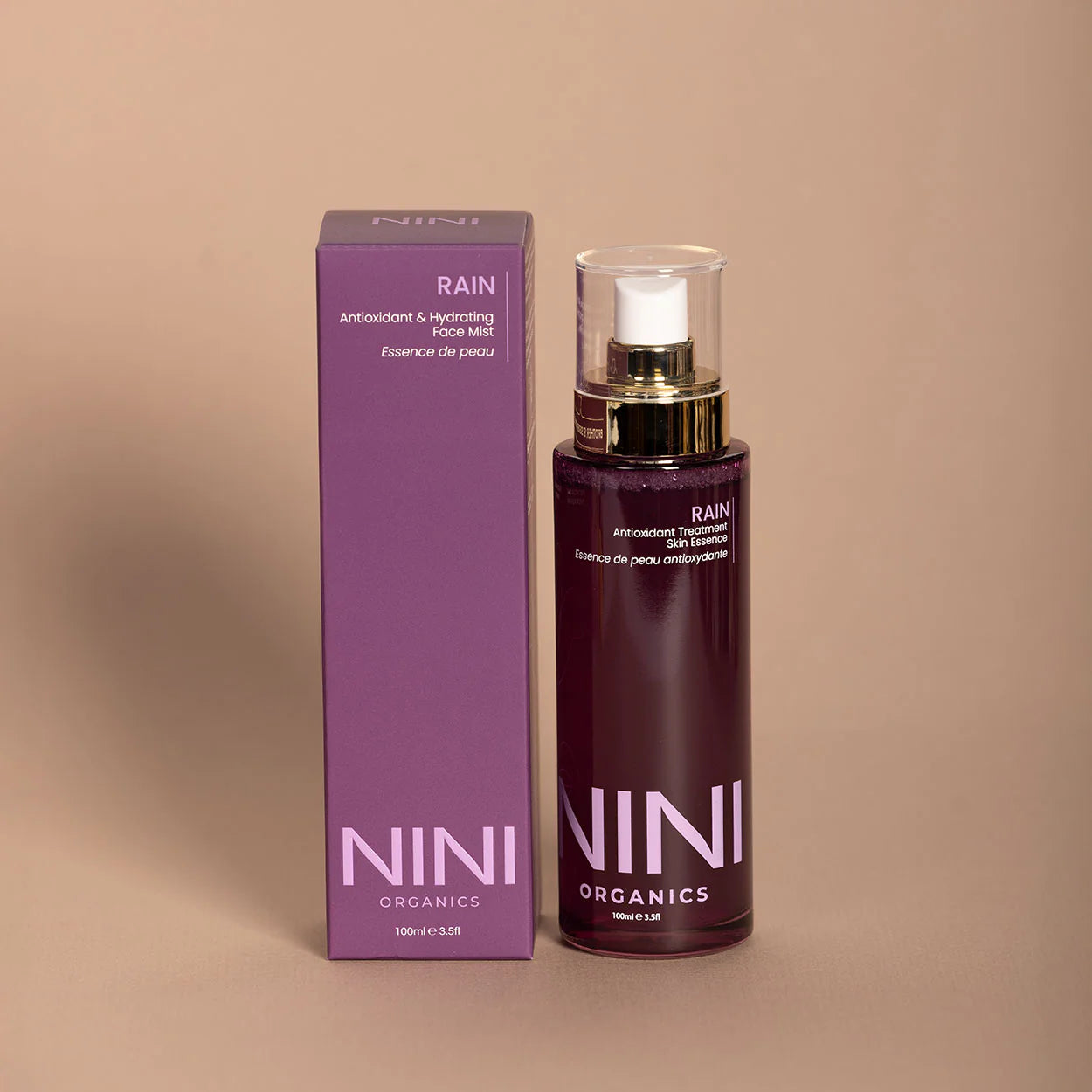 NINI Organics Rain hydrating mist product and packaging on a beige background