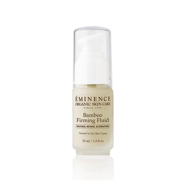 A clear bottle with a white label containing the Éminence Organic Bamboo Firming Fluid, designed for skin care.