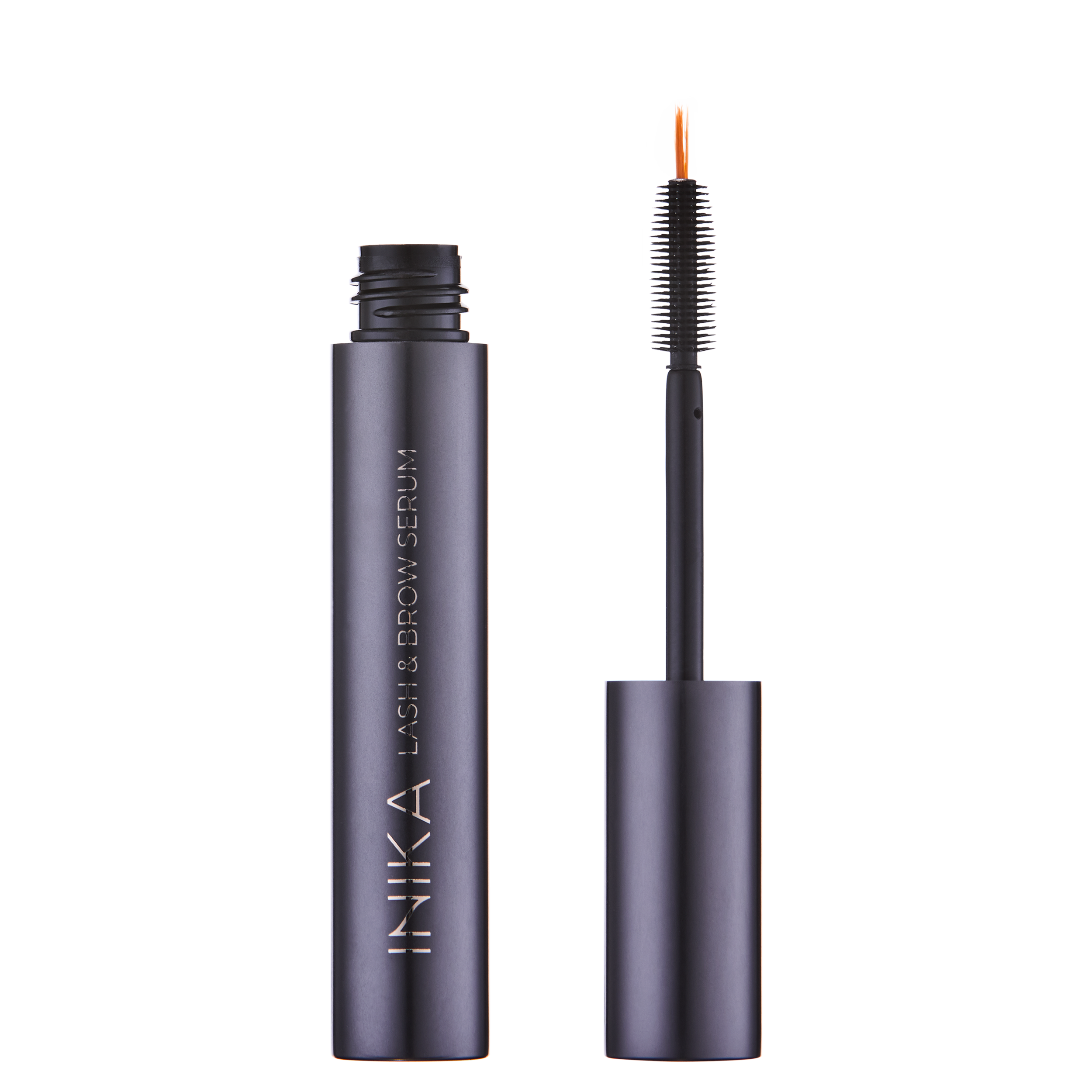 A bottle of INIKA Organic Lash and Brow Serum with the cap removed, showing the applicator brush with bristles coated in serum.